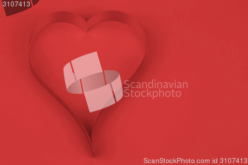 Image of valentine's paper hearts on a red background