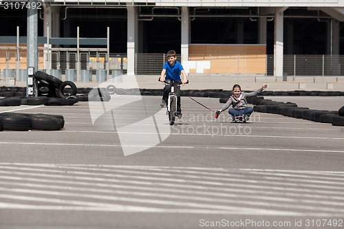 Image of Cyclist and skateboarder