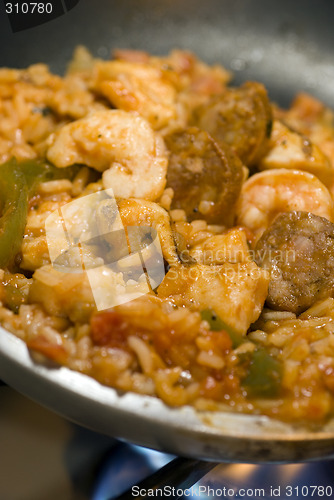 Image of  Jambalaya southern usa creole dish of shrimps chicken ham pork wild rice sausage and vegetables spicy