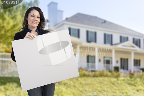 Image of Hispanic Female Holding Blank Sign In Front of House