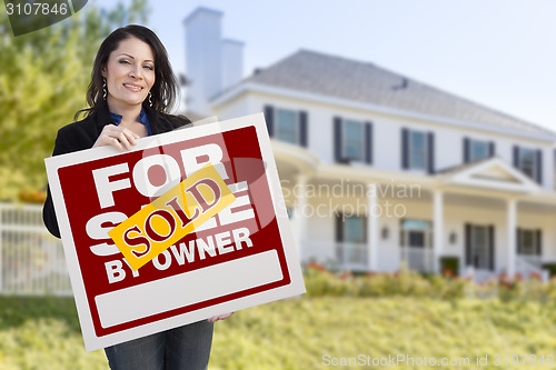 Image of Female Holding Sold By Owner Sign In Front of House