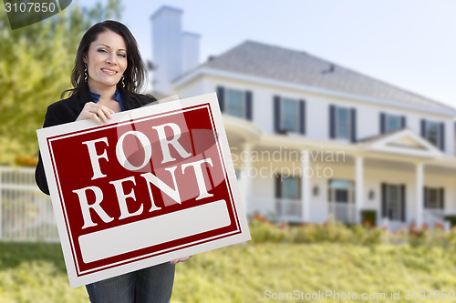 Image of Hispanic Female Holding For Rent Sign In Front of House