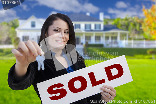 Image of Woman Holding Sold Sign and Keys In Front of House