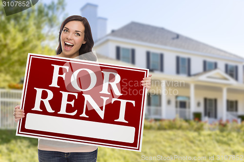 Image of Ethnic Female Holding For Rent Sign In Front of House