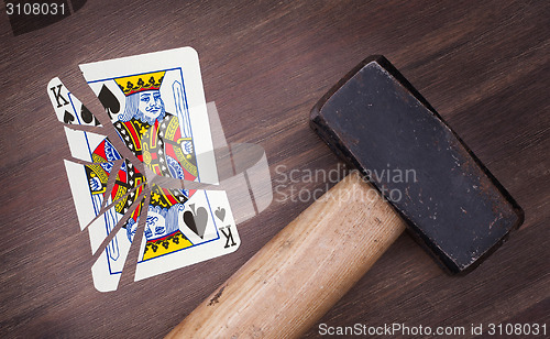 Image of Hammer with a broken card, king of spades
