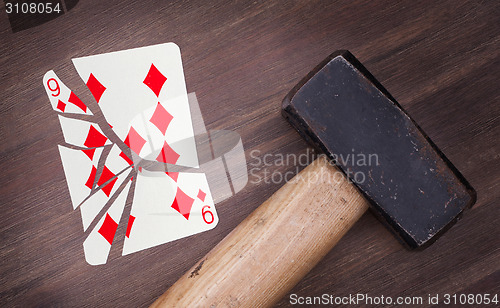 Image of Hammer with a broken card, nine of diamond