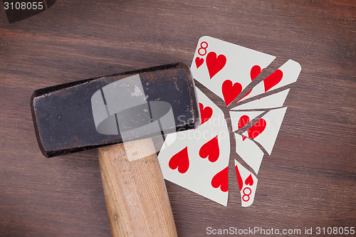 Image of Hammer with a broken card, eight of hearts