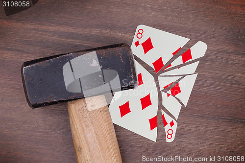 Image of Hammer with a broken card, eight of diamonds