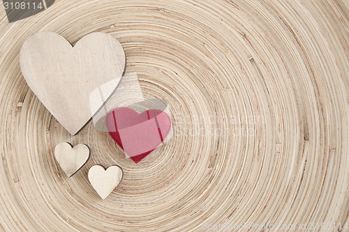 Image of valentine's wooden hearts on a wooden background