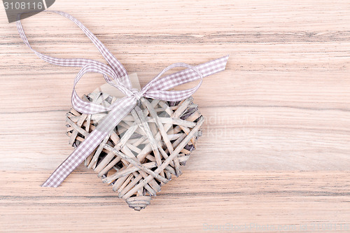 Image of valentine's wooden hearts on a wooden background in retro color