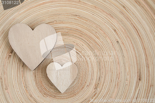 Image of valentine's wooden hearts on a wooden background