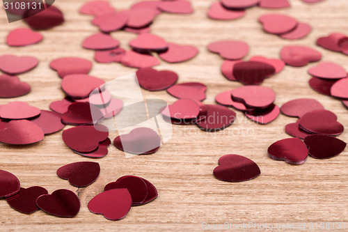 Image of Red hearts confetti on wooden background