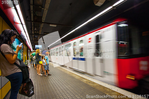 Image of Barcelona metro station with train in motion