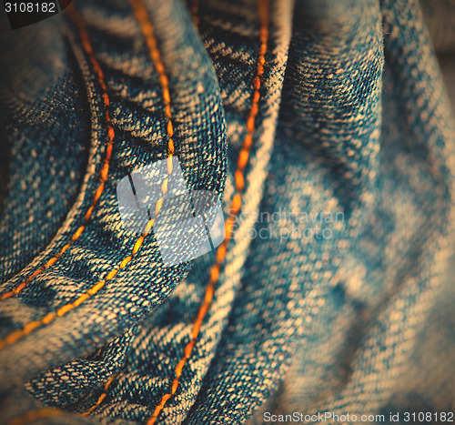 Image of blue Jeans with yellow stitching thread