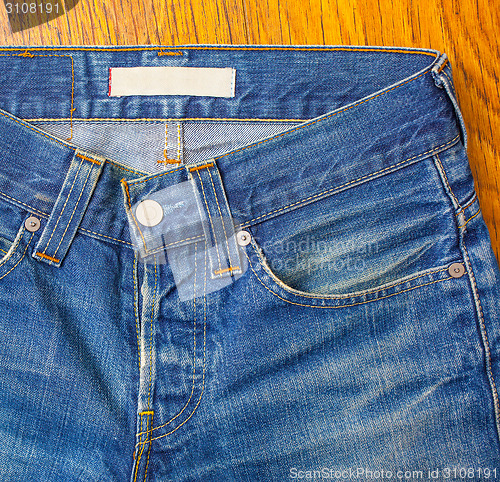 Image of indigo jeans with a button