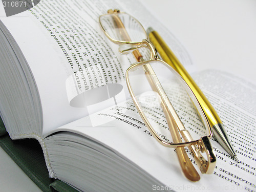 Image of glasses & pen on book 1