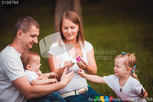 Image of Happy family with nesting box and paints