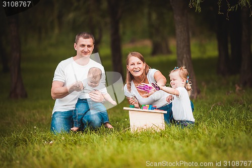 Image of Happy family with nesting box and paints