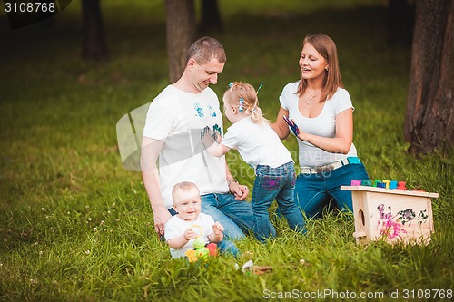 Image of Happy family with nesting box and paints