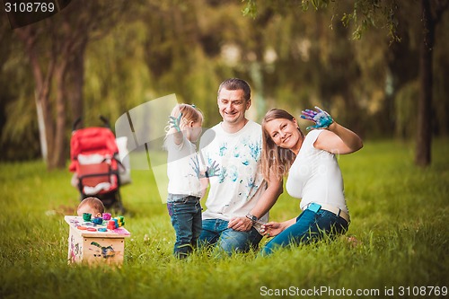 Image of Happy family with nesting box and paints