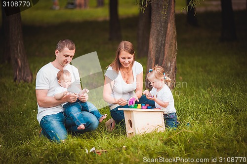 Image of Happy family with nesting box and paints