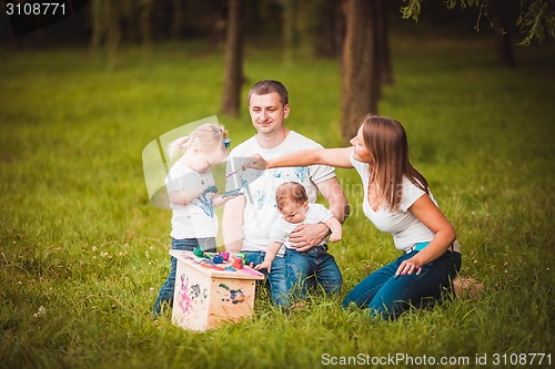 Image of Happy family with nesting box and paints
