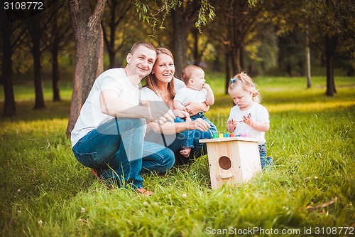 Image of Happy family with nesting box and paints