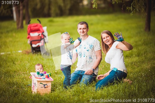 Image of Happy family with nesting box and paints