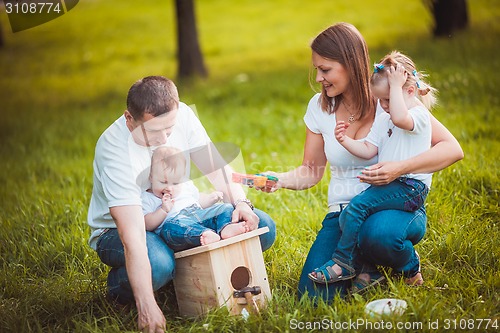 Image of Happy family with nesting box and paints