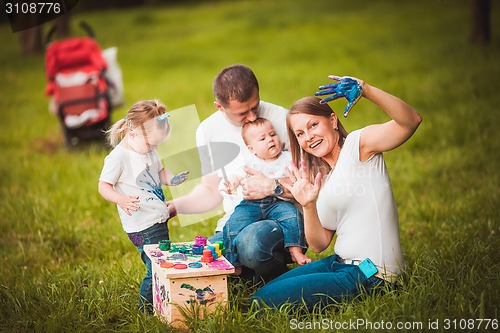 Image of Happy family with nesting box and paints