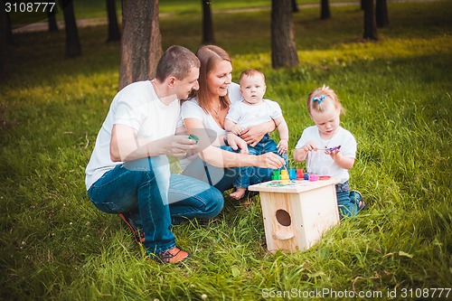 Image of Happy family with nesting box and paints