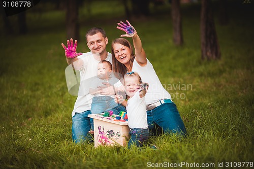 Image of Happy family with nesting box and paints