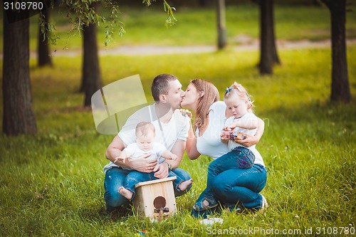 Image of Happy family with nesting box and paints