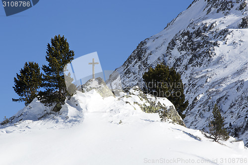 Image of Cross in snowy mountain landscape