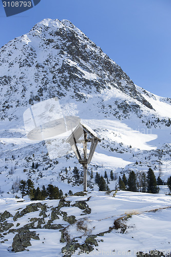 Image of Cross in snowy mountain landscape