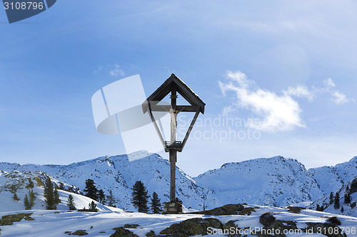 Image of Cross in snowy mountain landscape