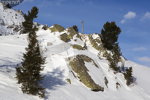 Image of Cross in snowy mountain landscape