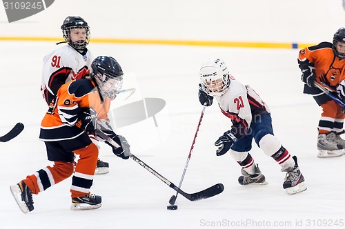 Image of Game between children ice-hockey teams