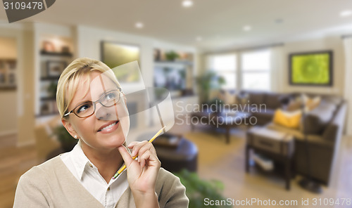 Image of Daydreaming Woman with Pencil Inside Beautiful Living Room