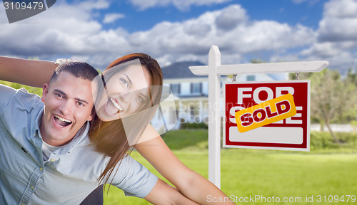 Image of Military Couple In Front of Home with Sold Sign