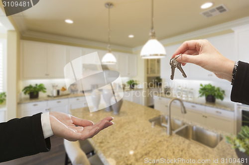 Image of Handing Over New House Keys Inside Beautiful Kitchen