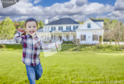 Image of Cute Mixed Race Boy Playing Ball in His Front Yard