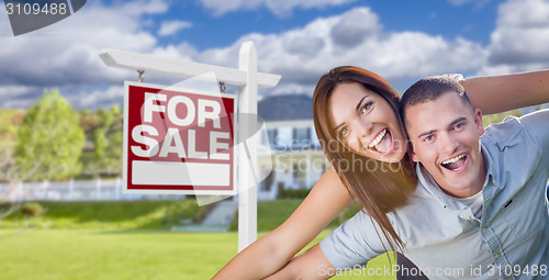 Image of Military Couple In Front of Home with For Sale Sign