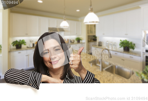 Image of Hispanic Woman With Thumbs Up in Beautiful Custom Kitchen