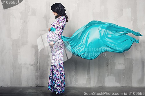 Image of Pregnant woman over gray background