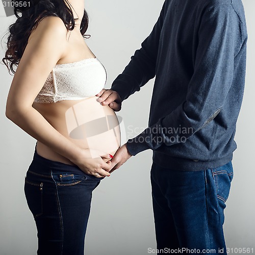 Image of Pregnant mother and happy father