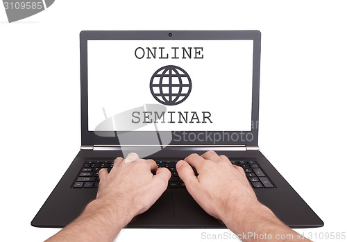 Image of Man working on laptop, online seminar