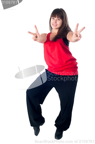 Image of Young attractive woman with victory gesture
