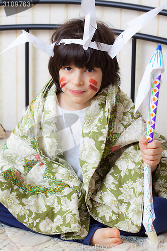 Image of boy with a spear in his hand