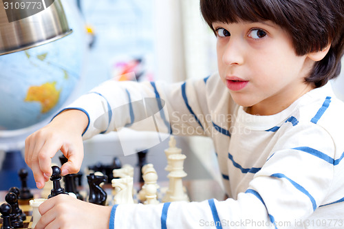 Image of boy playing a game of chess